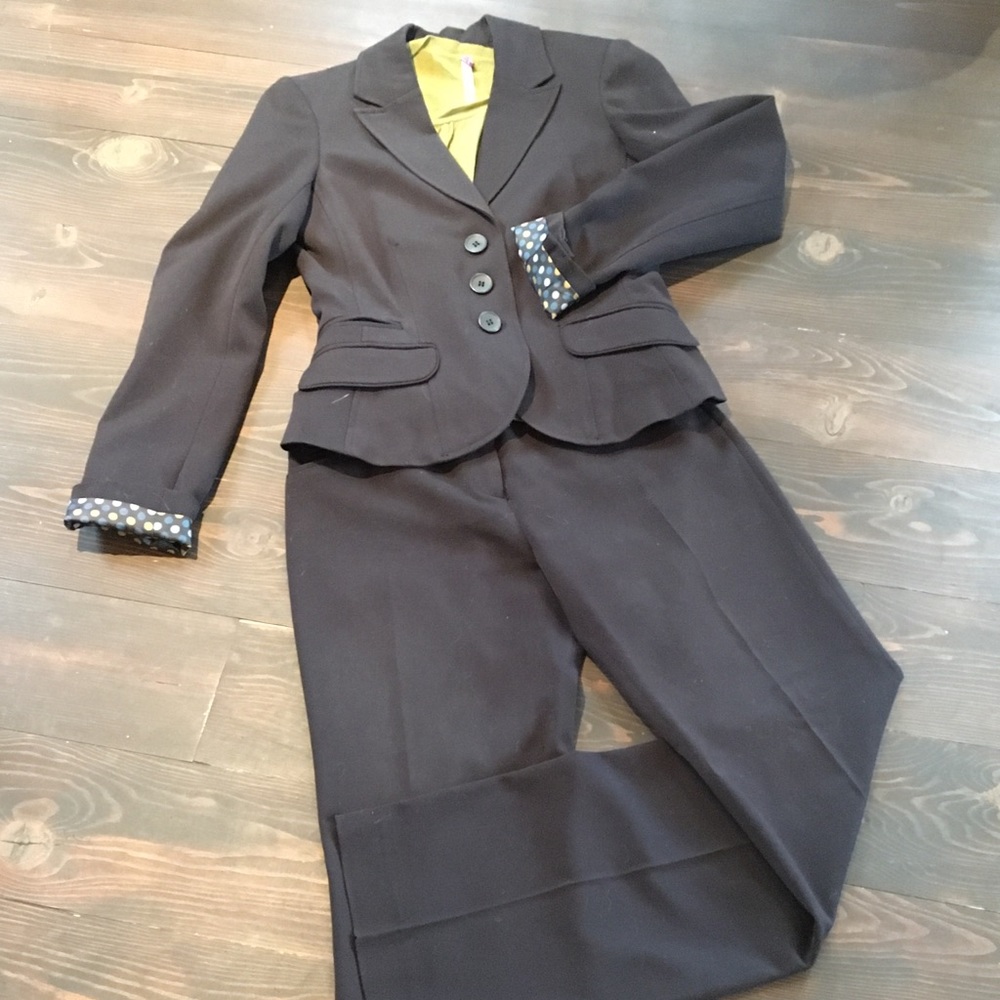 Black pant suit. Fitted jacket and straight leg pants with a slight boot cut.